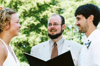 Reverend Erik performs a wedding ceremony outside.